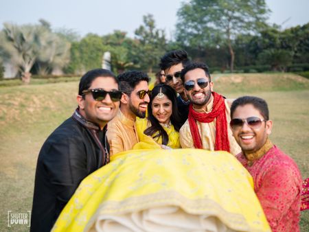 Bride with bridesmen picking her