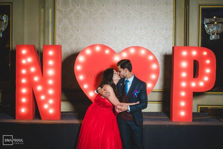 Couple kissing with their name initials. 