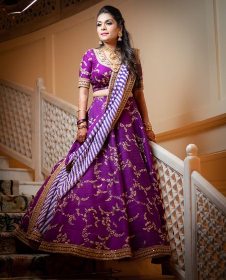 A bride in a purple lehenga for her cocktail