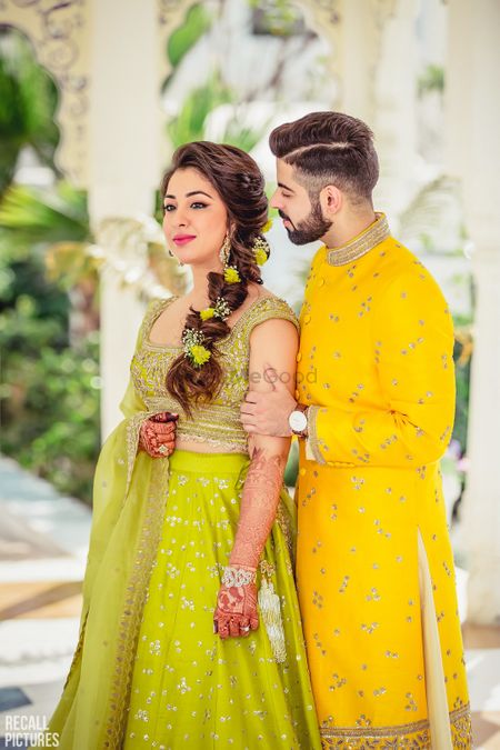 Lime green lehenga with floral braided hairstyle