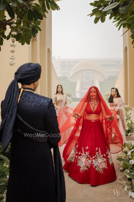 Classic bridal entry shot with the bride entering under a sheer veil along with her bridesmaids