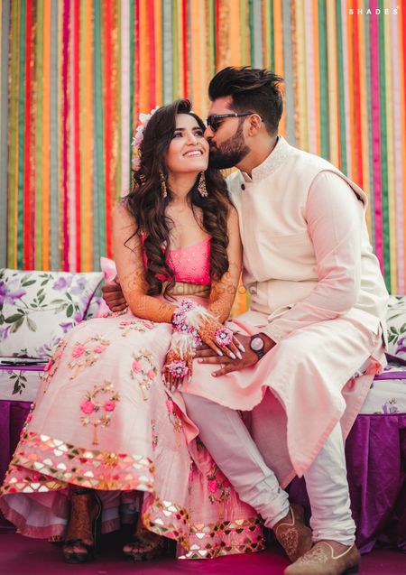 A color-coordinated couple on their mehendi ceremony