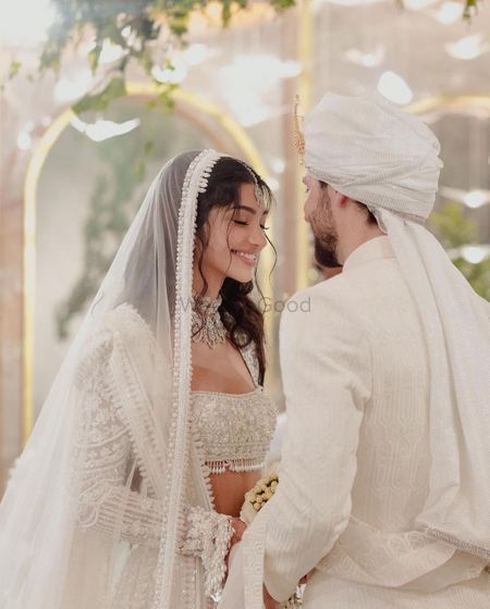 Alanna and Ivor in white custom Manish Malhotra outfits on their wedding day 
