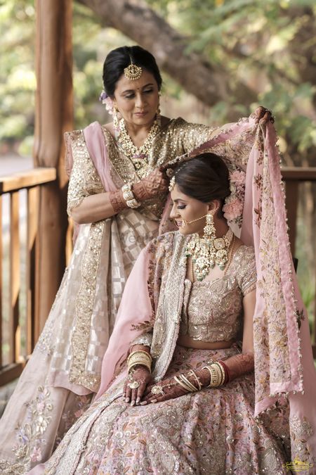 Bride posing with her mother on her wedding day.