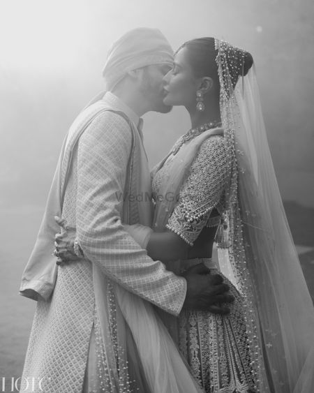 Classic couple portrait of the couple kissing on their wedding day