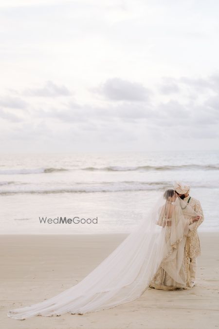 Wedding day portrait of the bride and groom on the beach