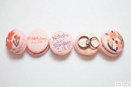 Cute personalised engagement ring shot with pastel macarons