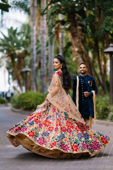 Twirling bride in multi-hued lehenga