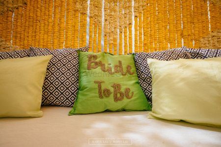 Photo of Bright pillow with 'bride to be' written on it for Mehendi seating for the bride.