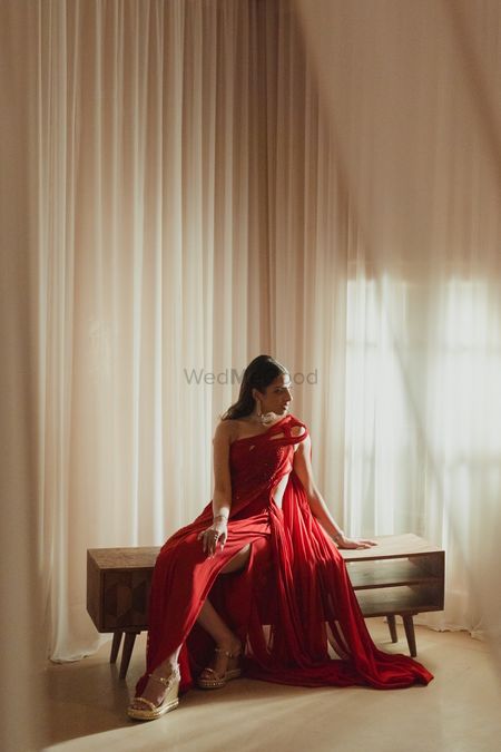 Photo of Bridal portrait in a super glamorous red gown with structured and cut-out details