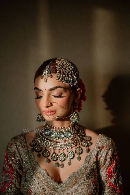 Lovely bridal shot with bride wearing statement polki and jadau jewellery with a statement passa