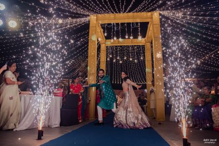 Bride and groom entry with sparklers at the sangeet 