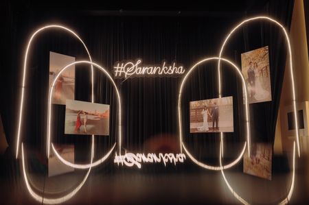 Personalized photobooth with bride and groom's photos and their wedding hashtag's signage. 