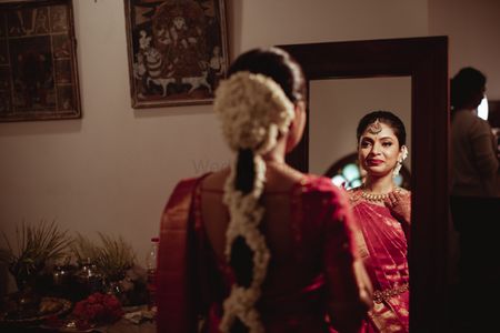 Getting ready shot of a South Indian bride.