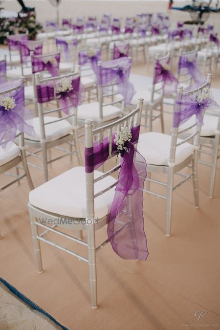 Purple and lavender ribbon decor with baby breath for chair backs