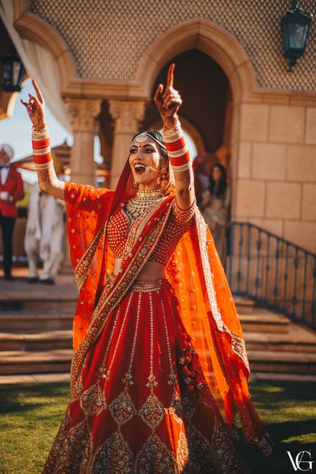 Photo of Bright and happy dancing bride shot on her wedding day