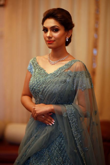 Engagement look with teal net lehenga with off shoulder blouse