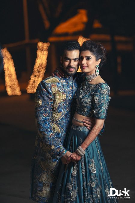 Photo of Teal blue or gunmetal grey crop top lehenga for sangeet or cocktail night with embroidered roses on it