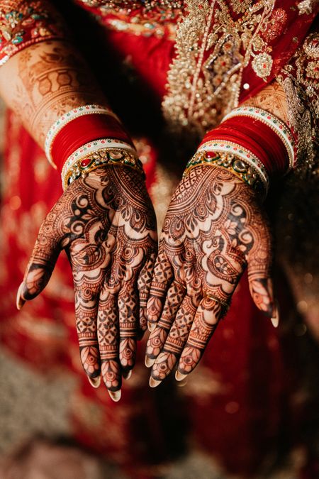 simple bridal mehendi hands with red chura