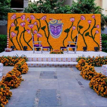 Photo of unique mandap decor with marigold wall