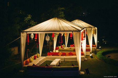 Photo of white and red cabana with lanterns