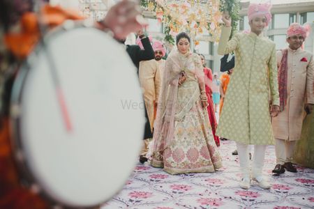 A beautiful bridal entry under a gorgeous phoolon ki chaadar 