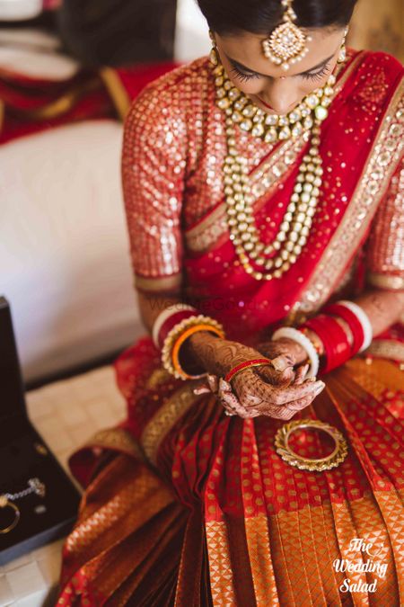 Bride close up shot putting on jewellery getting ready