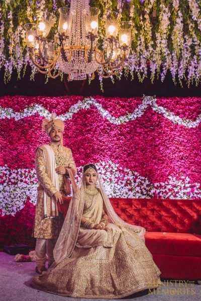 Coordinated bride and groom in gold outfits