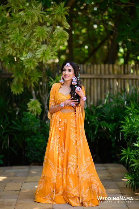 Breezy bridal Haldi look in yellow co-ords with a jacket and floral jewellery