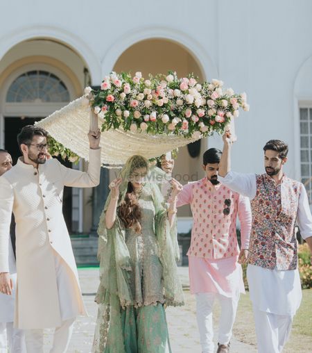 Photo of white bridal entry chadar with floral decoration