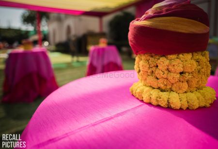 Photo of Unique mehendi centrepiece with pagri and genda phool