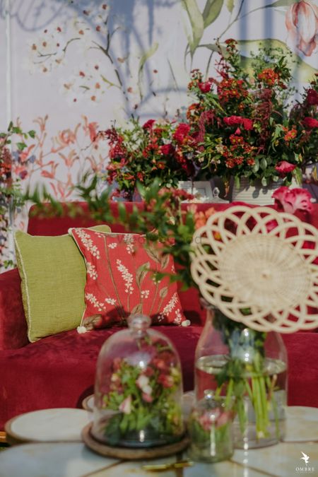 Photo of mehendi or wedding seating idea with cute cushions and florals