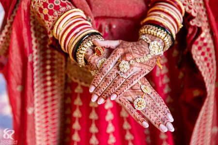 Photo of bridal hand mehendi shot with jewellery