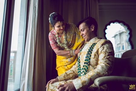 Photo of Groom with his mother wearing a contrasting necklace