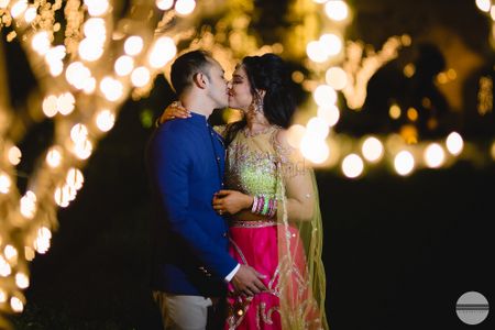 Romantic couple kissing shot with fairy lights 