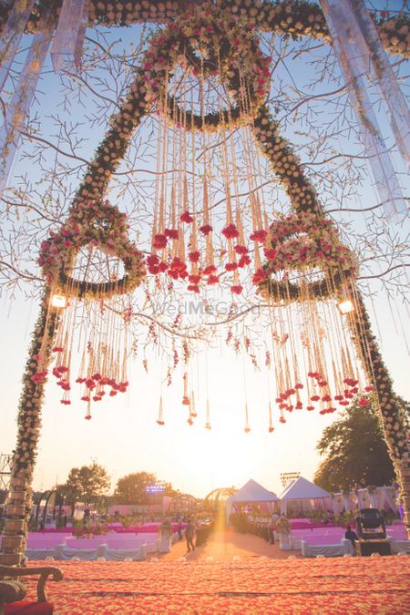 Floral chandeliers suspended from mandap