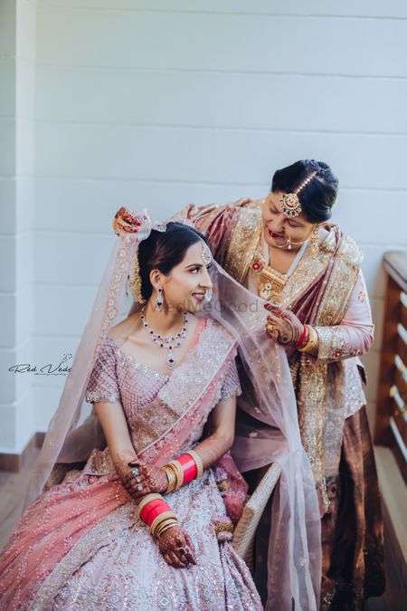 Photo of A bride in a unique pink and lavender lehenga and diamond jewellery