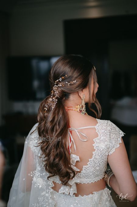 Photo of Simple yet unique wedding day hairstyle for the bride with delicate hair jewels