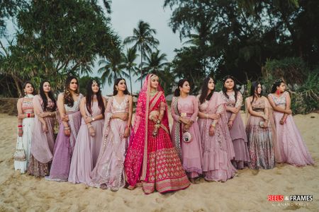 Photo of Bride with coordinated bridesmaids on wedding day