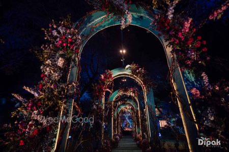 Photo of Arch ways lit up with gorgeous lights and floral decor for the sangeet night