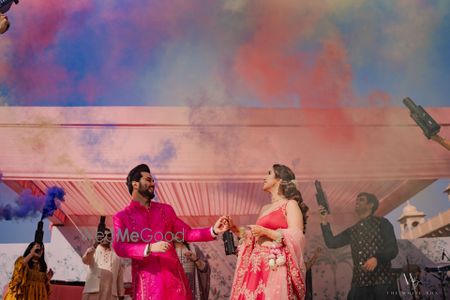 Photo of Fun couple entry with colourful smoke bombs for the pre-wedding ceremony