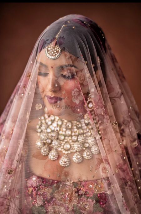 pretty bridal shot with a printed dupatta as veil