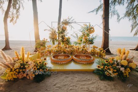 Fun and yellow themed set up for this beach haldi ceremony