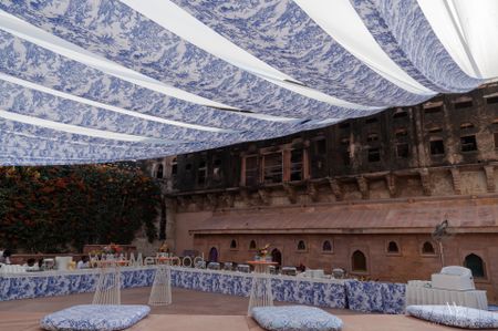 Lovely white and blue printed drapes for an outdoor tent style set up for the mehendi