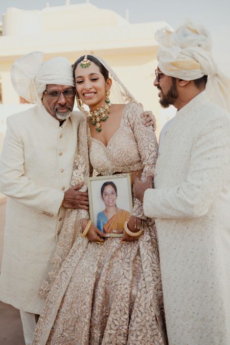 Emotional moment between the bride and her father and brother with late mom's memory photo