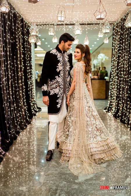 A bride and groom in coordinated clothes for their sangeet ceremony