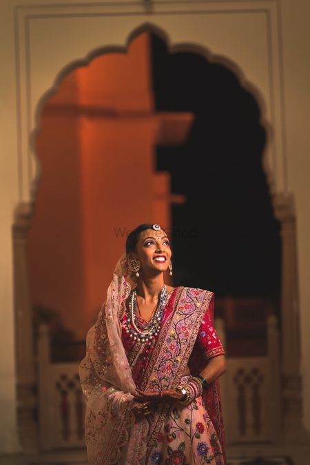 A bride in unique, multi-colored jewelry and double dupatta