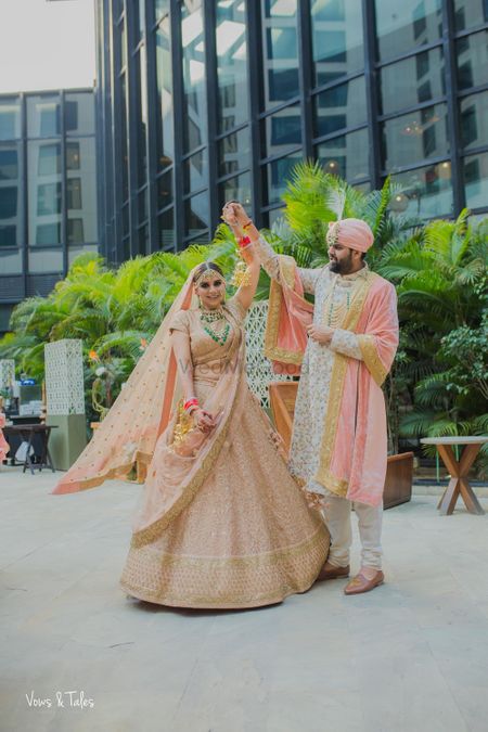 Photo of Matching bride and groom in peach outfits