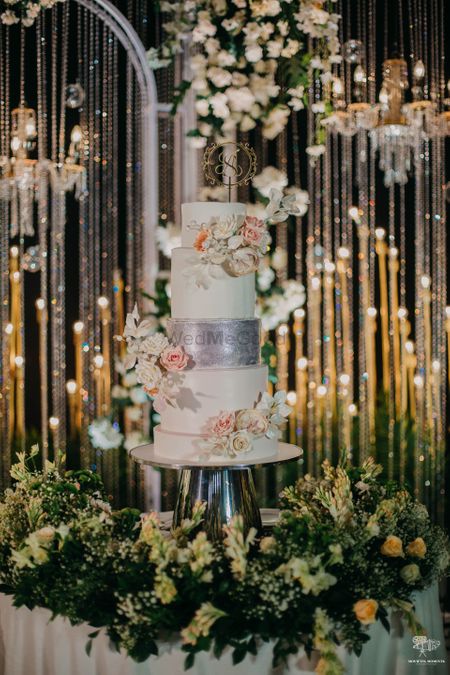Photo of three tier wedding cake with florals