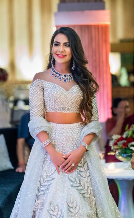 Pretty off shoulder blouse with silver lehenga 
